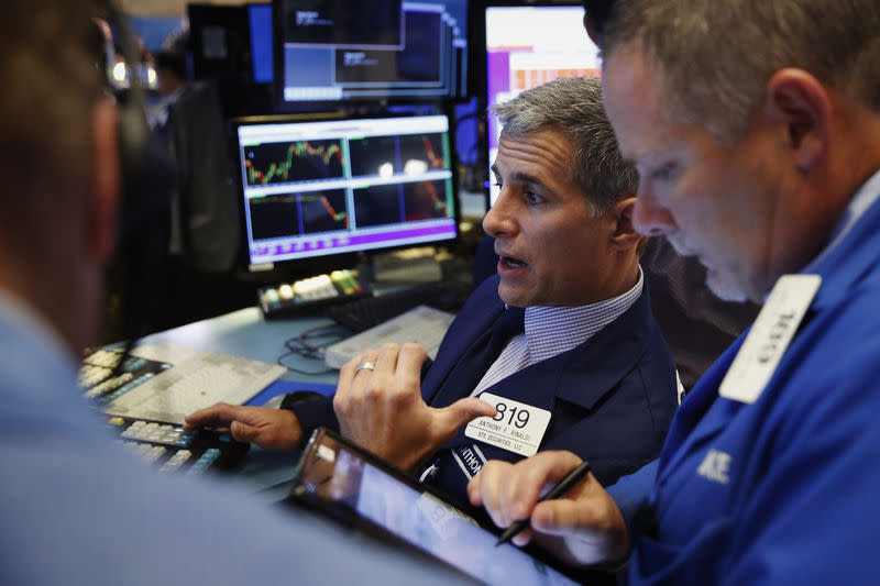 Traders work on the floor of the New York Stock Exchange (NYSE) shortly after the opening bell in New York, U.S., October 19, 2016. REUTERS/Lucas Jackson