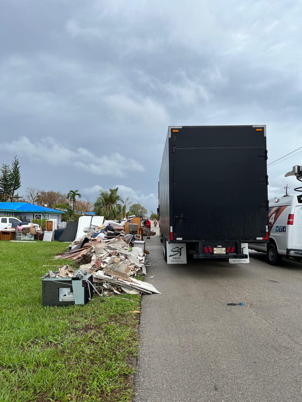 Contractor Hendrix drives through a neighborhood in southeast Cape Coral to pick up storm debris.