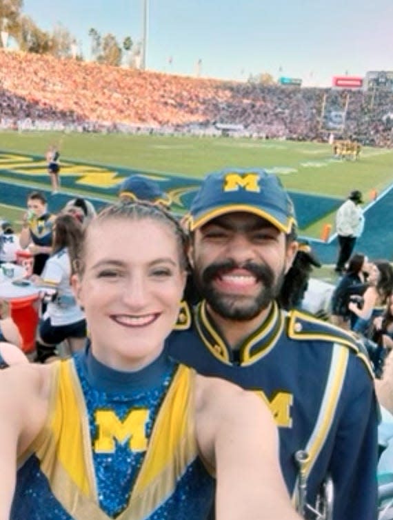 Grand Haven's Lauren Streng, left, and a marching band member pose in the stands at the Rose Bowl in Pasadena, California, on Jan. 1.