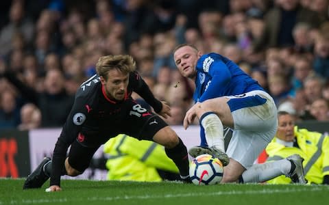 Nacho Monreal (L) in action with Wayne Rooney