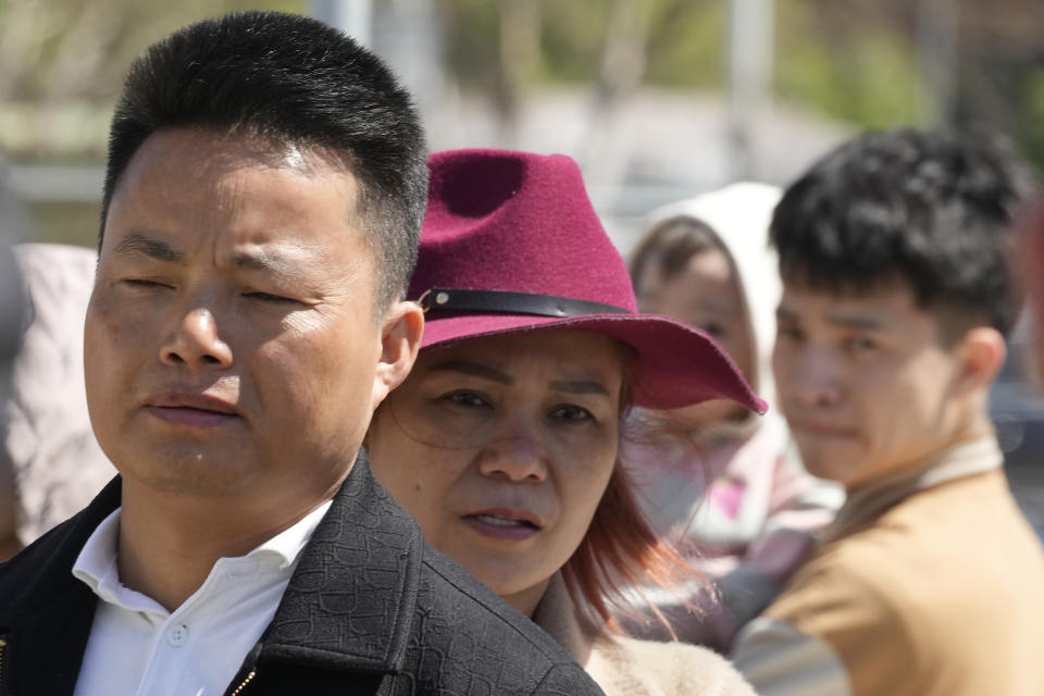 Nguyen Van Son, left, a Vietnamese merchant, is pictured in Warsaw, Poland, Wednesday, May 15, 2024, outside a shopping center destroyed in a weekend fire. A weekend fire in a shopping center in Warsaw dealt tragedy to many members of Poland's Vietnamese community. People lost entire livelihoods and say they don't know how they will manage to make a living. (AP Photo/Czarek Sokolowski)