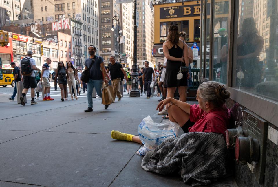 A woman rests on a Manhattan street during a heat wave on July 22, 2022 in New York City. For the thousands of New Yorkers who live on the city's streets, relief from the heat is hard to find. Around the United States, heat causes an estimated 1,500 deaths annually, and advocates estimate that about half of those people are homeless. Much of the East Coast is experiencing higher than usual temperatures as a heat wave moves through the area forcing residents into parks, pools and beaches to escape the heat.