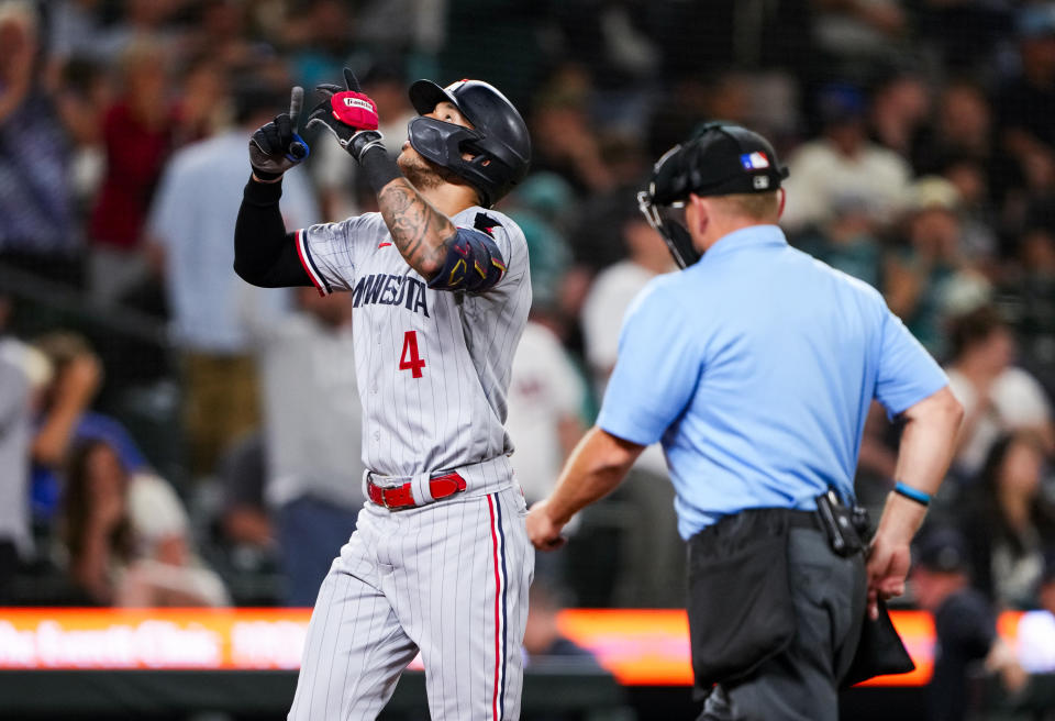 Minnesota Twins' Carlos Correa points to the sky after hitting a home run against the Seattle Mariners during the ninth inning of a baseball game, Tuesday, July 18, 2023, in Seattle. The Twins won 10-3. (AP Photo/Lindsey Wasson)