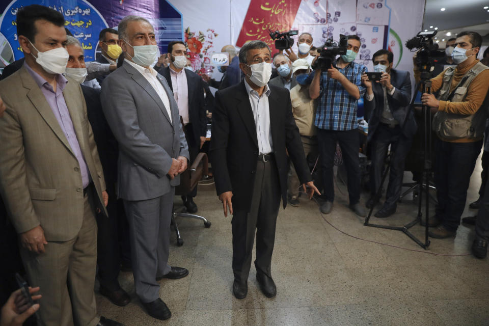 Former President Mahmoud Ahmadinejad speaks with journalists while registering his name as a candidate for the June 18, presidential elections at elections headquarters of the Interior Ministry in Tehran, Iran, Wednesday, May 12, 2021. The country's former firebrand president will run again for office in upcoming elections in June. The Holocaust-denying Ahmadinejad has previously been banned from running for the presidency by Supreme Leader Ayatollah Ali Khamenei in 2017, although then, he registered anyway. (AP Photo/Vahid Salemi)