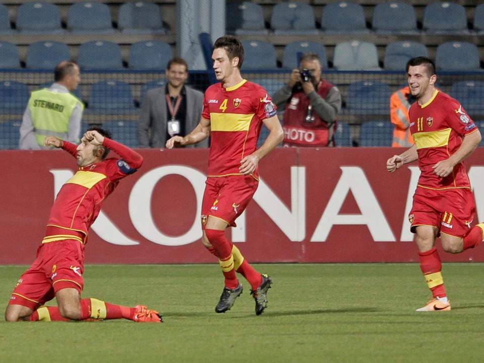 Montenegro`s Mirko Vucinic (L) celebrates with Nikola Vukcevic and Fatos Baciraj (R) after scoring a goal during their Euro 2016 qualifying soccer match in Podgorica, Montenegro in 2015.