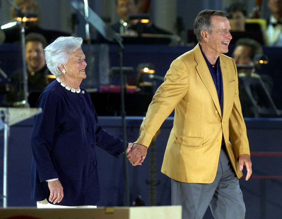 Former President George H.W. Bush and Barbara Bush smile as they are introduced at his&nbsp;80th birthday celebration at Minute Maid Stadium on June 12, 2004, in Houston, Texas.