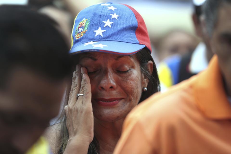 A Venezuelan citizen cries during a protest against Venezuelan President Nicolas Maduro outside the Venezuelan embassy on the day Maduro is sworn in for a second term, in Lima, Peru, Thursday, Jan. 10, 2019. Maduro started a new, six-year term Thursday despite international cries urging him to step down and return democratic rule to a country suffering a historic economic implosion. (AP Photo/Martin Mejia)