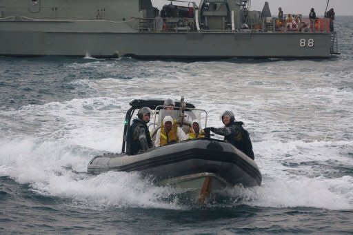 Australian navy personnel transfer Afghanistan asylum-seekers to a Indonesian rescue boat near Panaitan island, West Java after the refugee's boat sunk