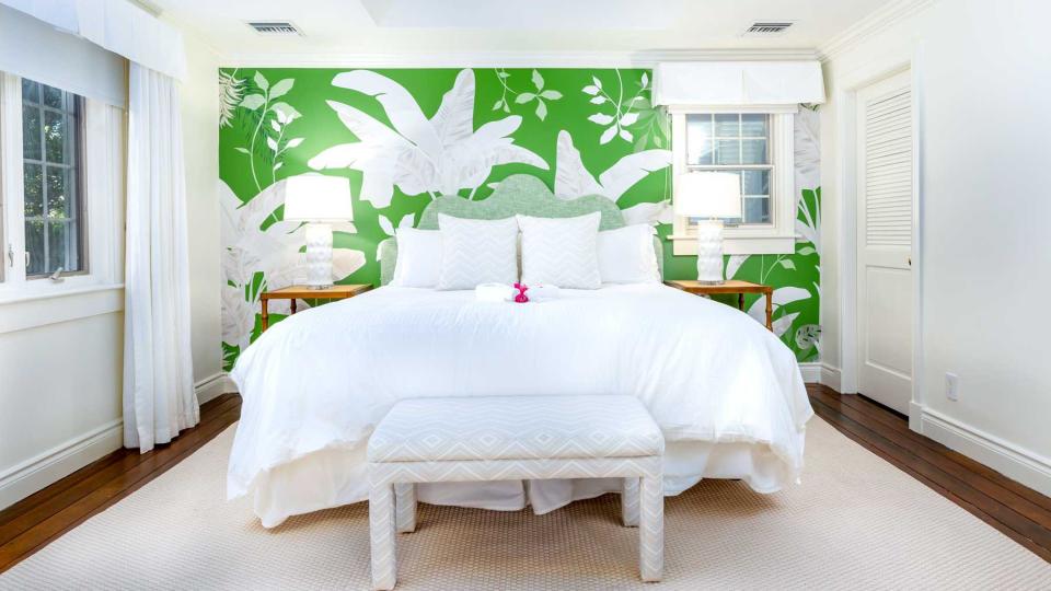 A green and white guest room at Point Grace, voted one of the best resorts in the Caribbean