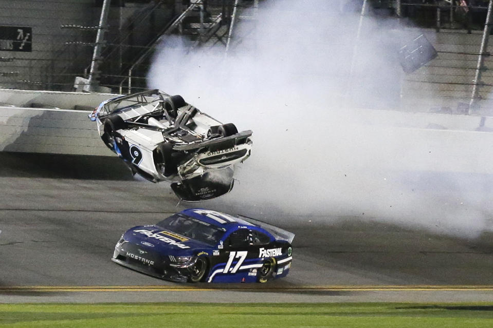 Chris Buescher (17) goes low to avoid Ryan Newman (6) a he wrecks and flips on the final lap of the NASCAR Daytona 500 auto race at Daytona International Speedway, Monday, Feb. 17, 2020, in Daytona Beach, Fla. Sunday's race was postponed because of rain. (AP Photo/Terry Renna)