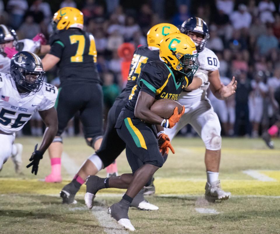 CJ Nettles (25) carries the ball during the Gulf Breeze vs Catholic football game at Pensacola Catholic High School in Pensacola on Thursday, Oct. 6, 2022.