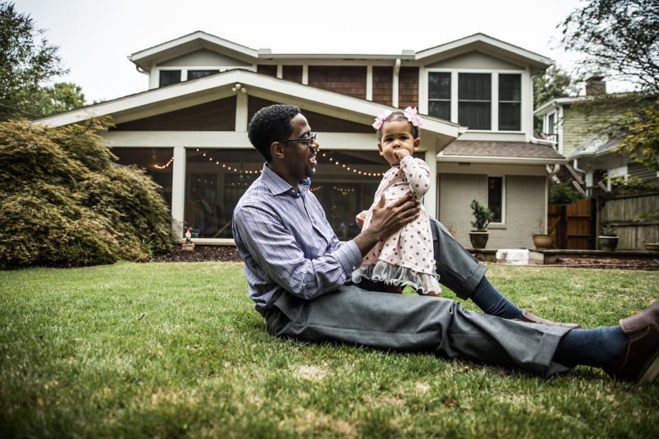 Father and daughter (18 months) playing in backyard