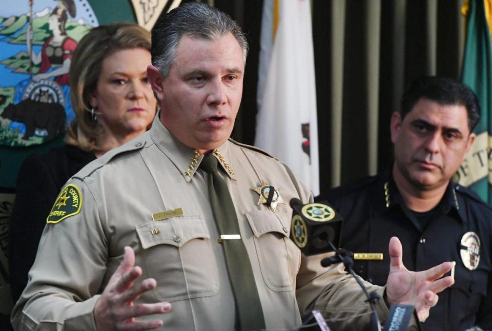 Fresno County Sheriff John Zanoni, with Fresno County District Attorney Lisa Smittcamp to the left in the background, and Selma Police Chief Rudy Alcaraz to the right, announces an update on the killing of Selma police officer Gonzalo Carrasco Jr. at a press conference Friday, Feb 3, 2023 in Fresno.