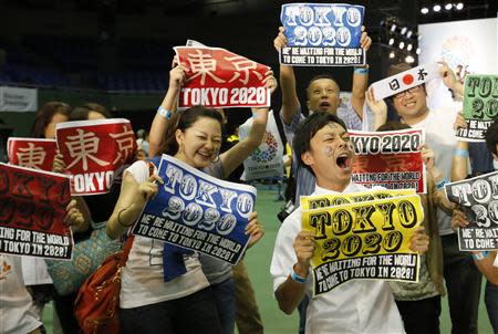 People celebrate after hearing that Tokyo had been chosen to host the 2020 Olympic Games during a public viewing event in Tokyo September 8, 2013. REUTERS/Toru Hanai