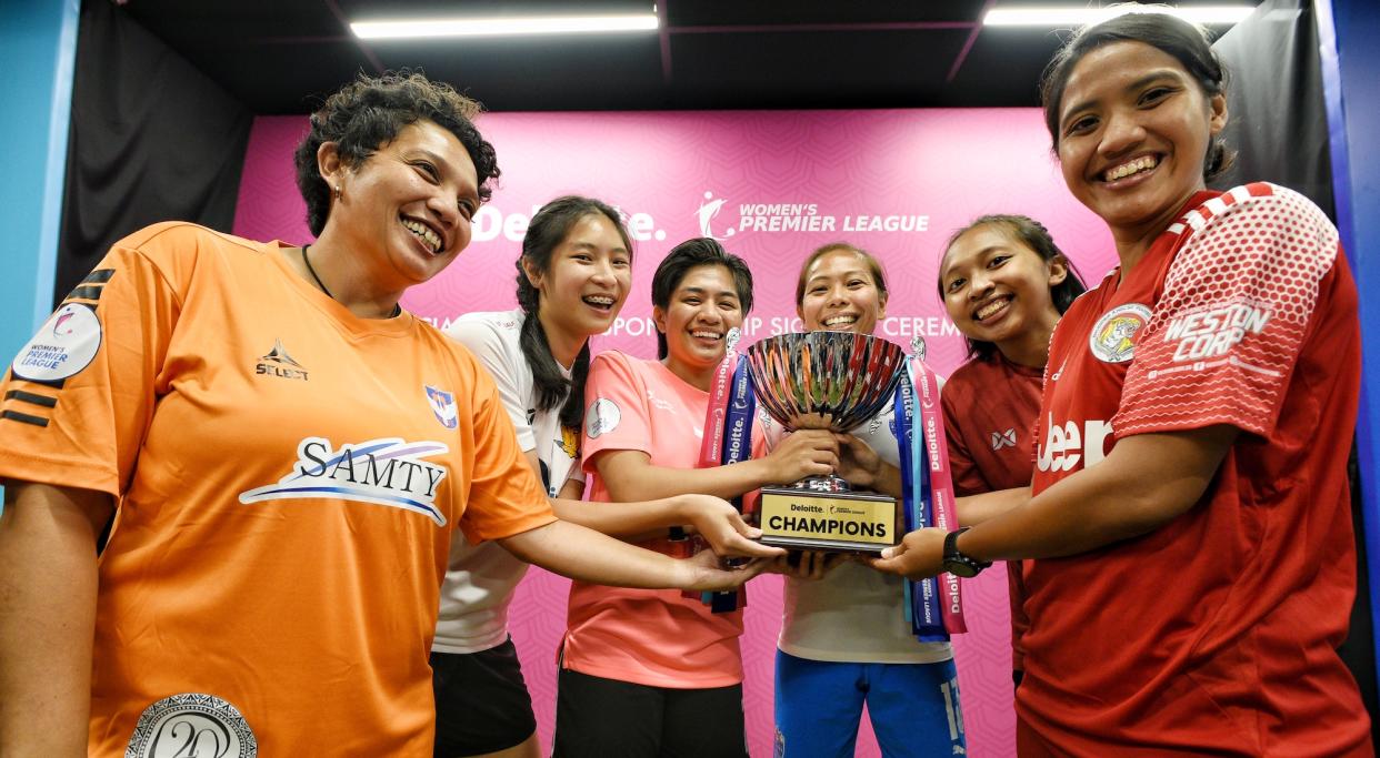 Deloitte Women's Premier League players with the league trophy. (PHOTO: Football Association of Singapore)