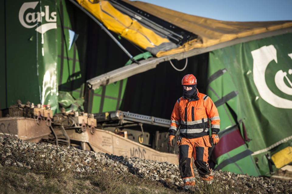 A view of the freight train, after a train accident on the Great Belt Bridge in Nyborg, Denmark, Wednesday, Jan. 2, 2019. A Danish passenger train apparently hit falling cargo from a passing freight train Wednesday, an accident that killed six people and injured 16 others as it crossed a bridge linking the country's islands, authorities said. Authorities said the trains were going past each other in opposite directions. Aerial TV footage showed one side of front of the passenger train had been ripped open. (Mads Claus Rasmussen/Ritzau Scanpix via AP)