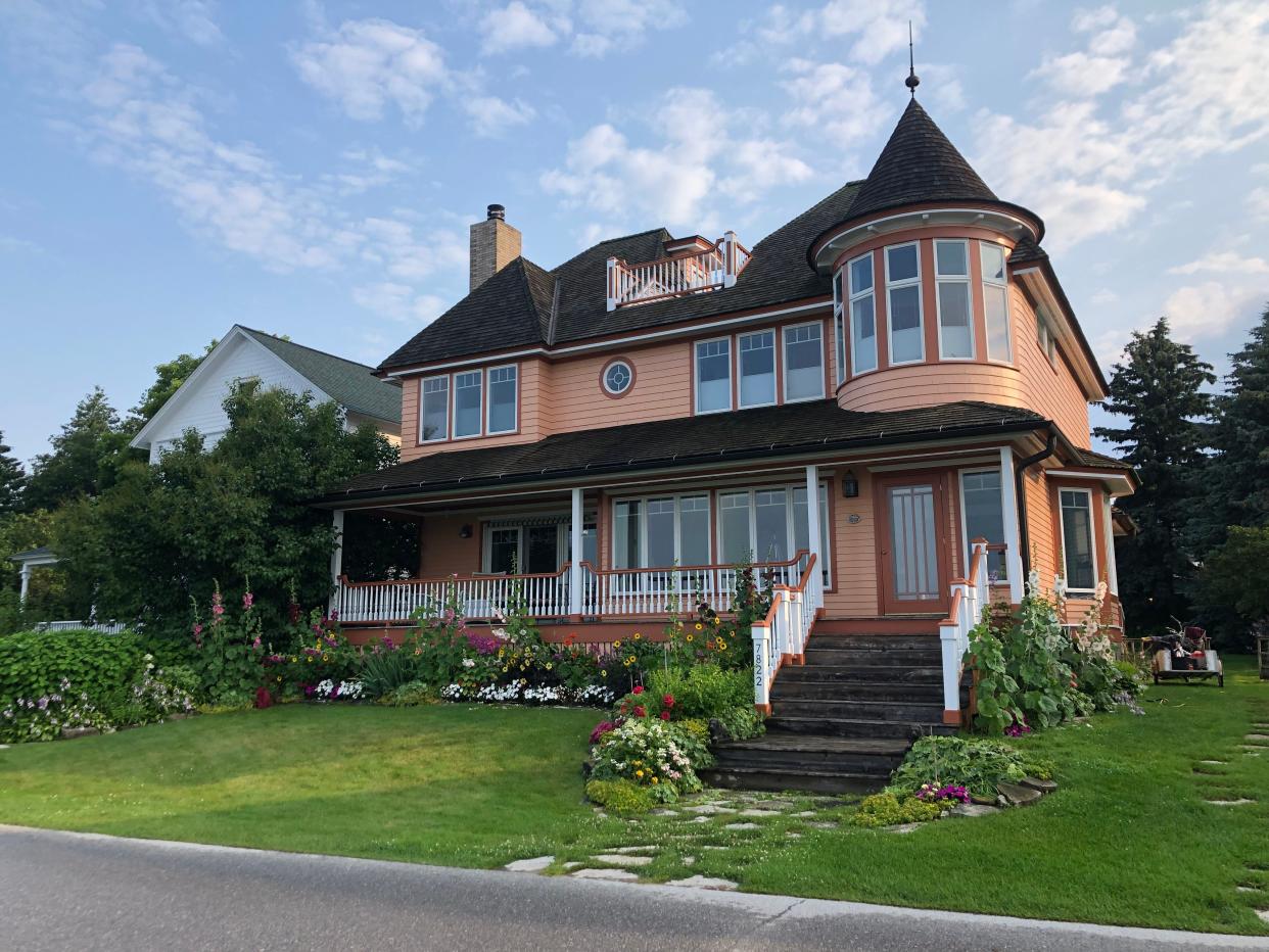 A beautiful home in Mackinac island with turrets and greenery