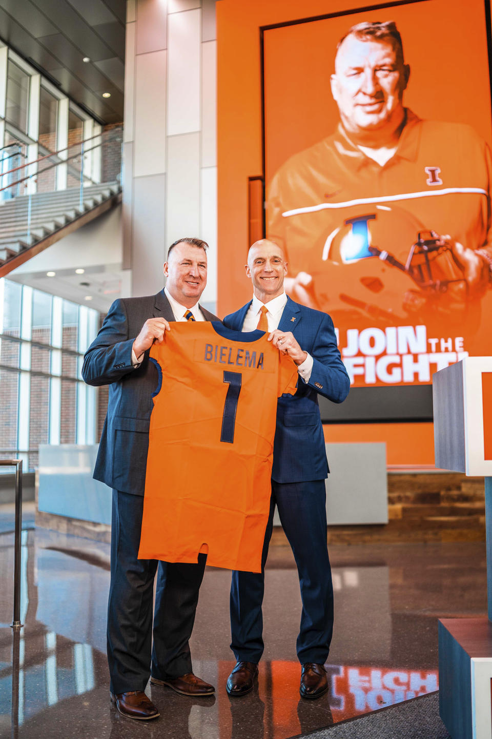 Incoming Illinois football coach Bret Bielema, left, is accompanied by Josh Whitman, Director of Athletics at Smith Football Center in Champaign, Ill., as he is introduced as the new football coach at U of I in this undated photo. Bielema said Monday, Dec. 21, 2020, he hopes to have a coaching staff in place by early January 2021, and is already concentrating on homegrown recruiting. (Michael Glasgow/University of Illinois Athletics via AP)