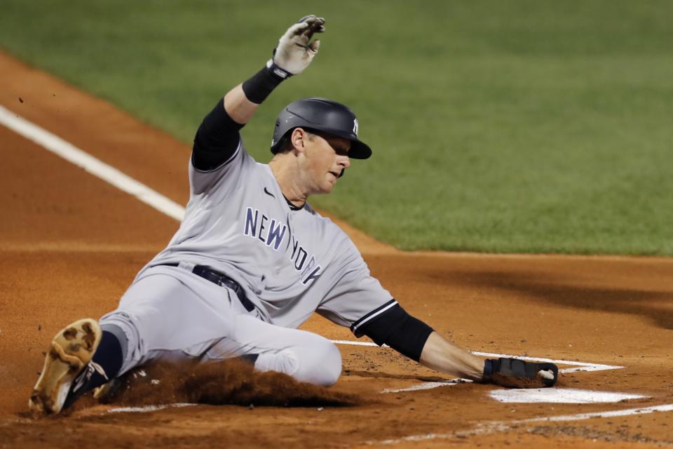 New York Yankees' DJ LeMahieu scores on a sacrifice fly by Gio Urshela during the first inning of a baseball game against the Boston Red Sox, Saturday, Sept. 19, 2020, in Boston. (AP Photo/Michael Dwyer)