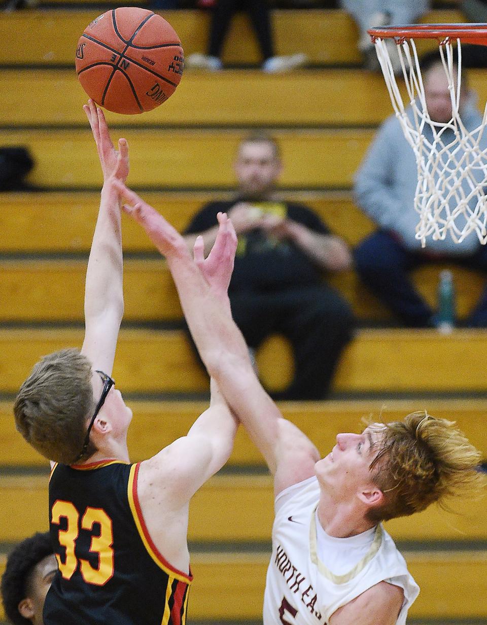 Girard junior Geremia Dell'Omo, left, scores in the first half over North East junior Noah Crozier in North East on Jan. 3.