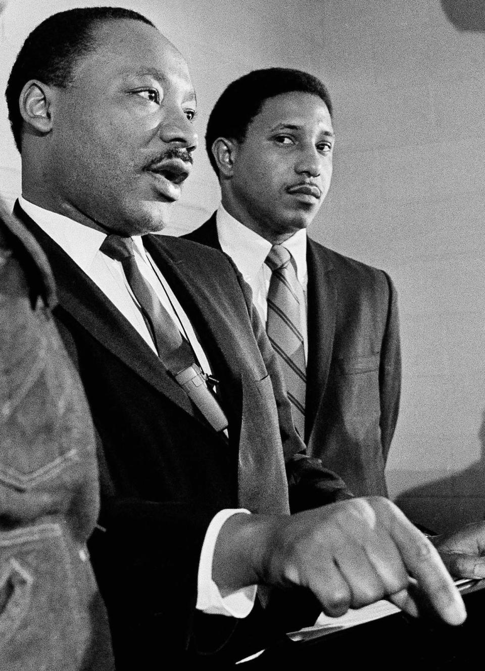 In this Tuesday, Jan. 16, 1968 file photo, Martin Luther King Jr., accompanied by the Rev. Bernard Lafayette, talks about a planned march on Washington, during a news conference in Atlanta.