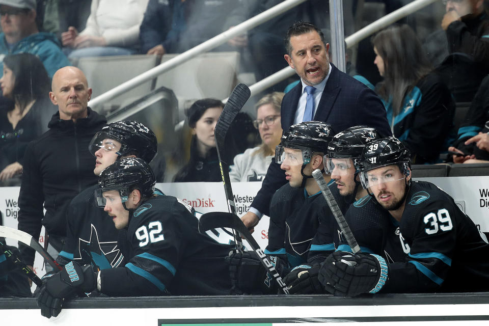 San Jose Sharks coach Bob Boughner stands behind players on the bench during the first period of the team's NHL hockey game against St. Louis Blues in San Jose, Calif., Thursday, April 21, 2022. (AP Photo/Josie Lepe)