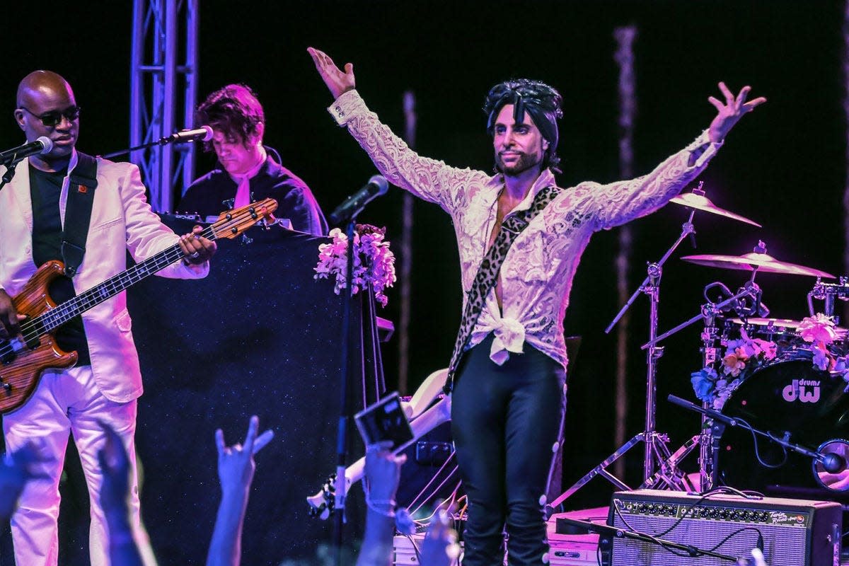 Marshall Charloff, lead singer for The Purple Xperience, poses for the audience during a performance.