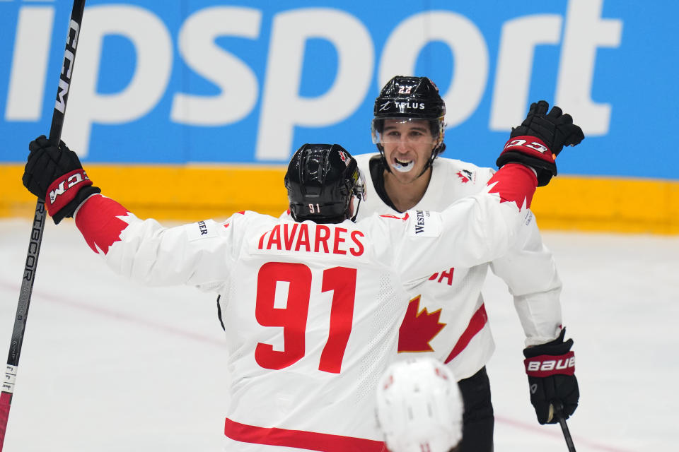 Canada's Dylan Cozens, right, celebrates with Canada's John Tavares after scoring his sides first goal during the preliminary round match between Canada and Switzerland at the Ice Hockey World Championships in Prague, Czech Republic, Sunday, May 19, 2024. (AP Photo/Petr David Josek)