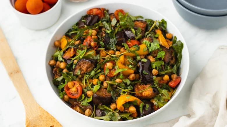 Roasted chickpea and eggplant salad in white bowl