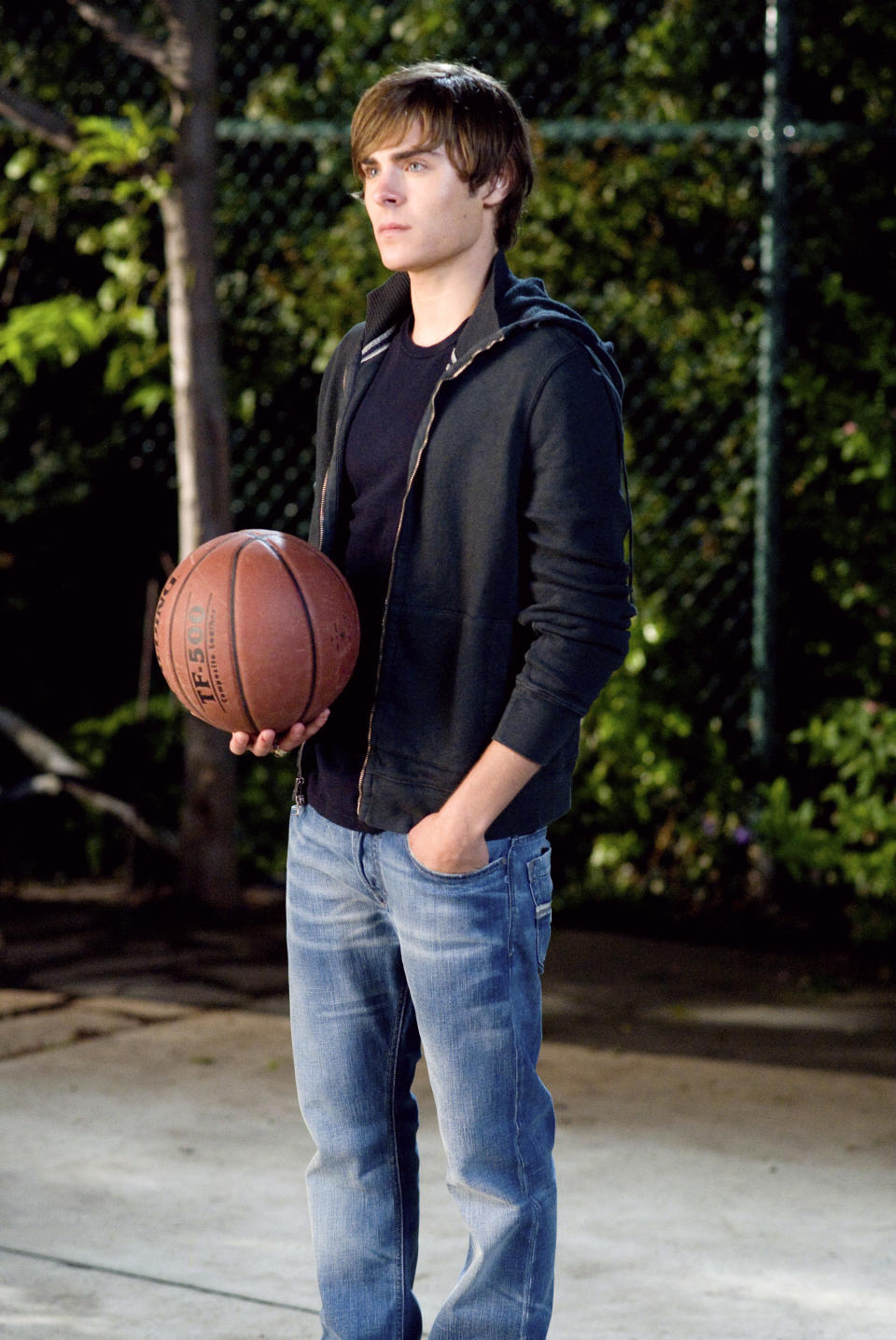 Zac holding a basketball in a scene from "High School Musical"