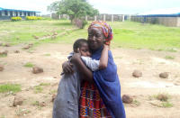 Parents are reunited with released students of the Bethel Baptist High School in Damishi, Nigeria, on Sunday, July 25, 2021. Armed kidnappers in Nigeria have released 28 of the more than 120 students who were abducted at the beginning of July from the Bethel Baptist High School in the northern town of Damishi. Church officials handed those children over to their parents at the school on Sunday. (AP Photo)