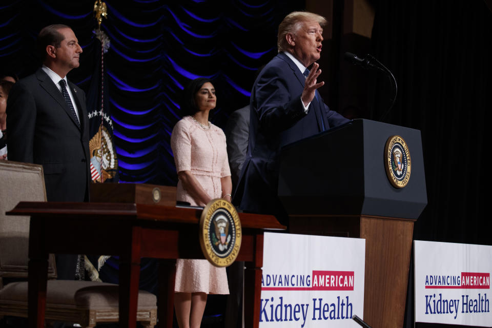 Secretary of Health and Human Services Alex Azar and administrator of the Centers for Medicare and Medicaid Services Seema Verma look on as President Donald Trump speaks during an event on kidney health at the Ronald Reagan Building and International Trade Center, Wednesday, July 10, 2019, in Washington. (AP Photo/Evan Vucci)