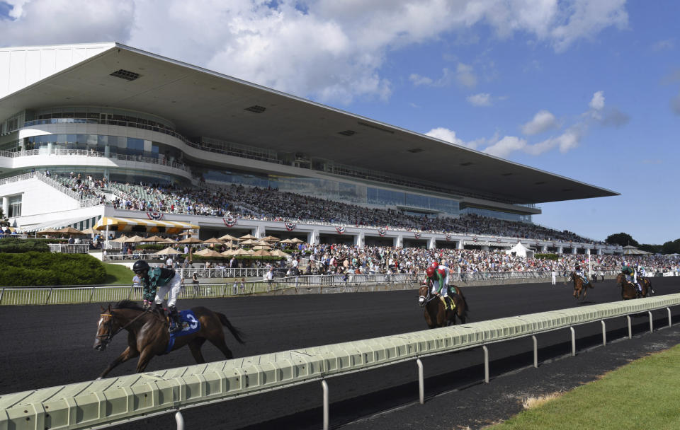 FILE - In this Aug. 12, 2017, file photo, horses in the Bruce D. Memorial Stakes pass the grandstand at Arlington International Racecourse in Arlington Heights, Ill. A potential move by the Chicago Bears has been picking up steam in recent weeks, after the team announced a bid to purchase Arlington International Racecourse. The famed thoroughbred track in the village of Arlington Heights sits about 30 miles northwest of Soldier Field on a 326-acre plot of land owned by Churchill Downs Inc. that is for sale. ( John Starks/Daily Herald via AP, File)