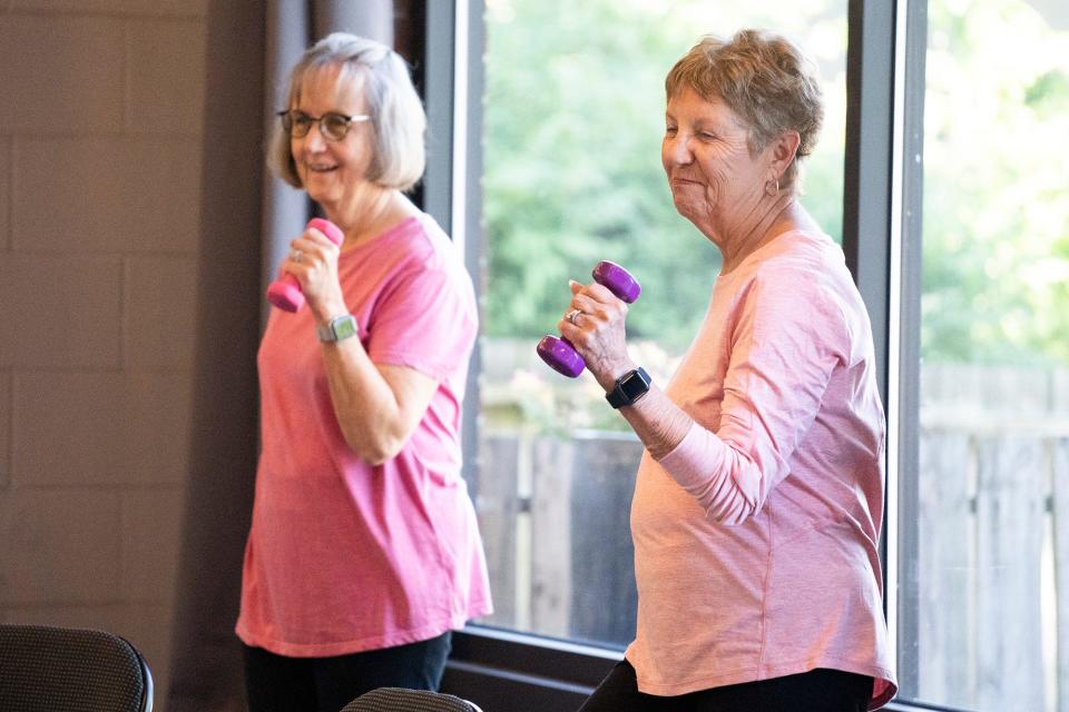 Elaine Karn, 71, left, and Felicia Bousquet, 82, warm up during an exercise class June 21 at the Bexley Senior Center.