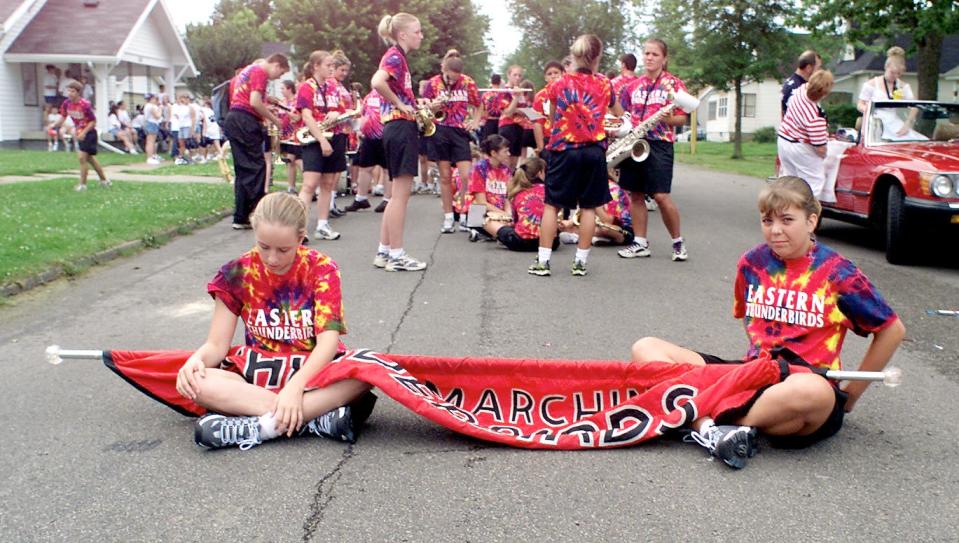 Brittany Sparks, left, and Sarah Cobine of the Eastern Greene County High School Thunderbird marching band, take a much needed rest while waiting for the Linton Freedom Festival on July 4, 2017.