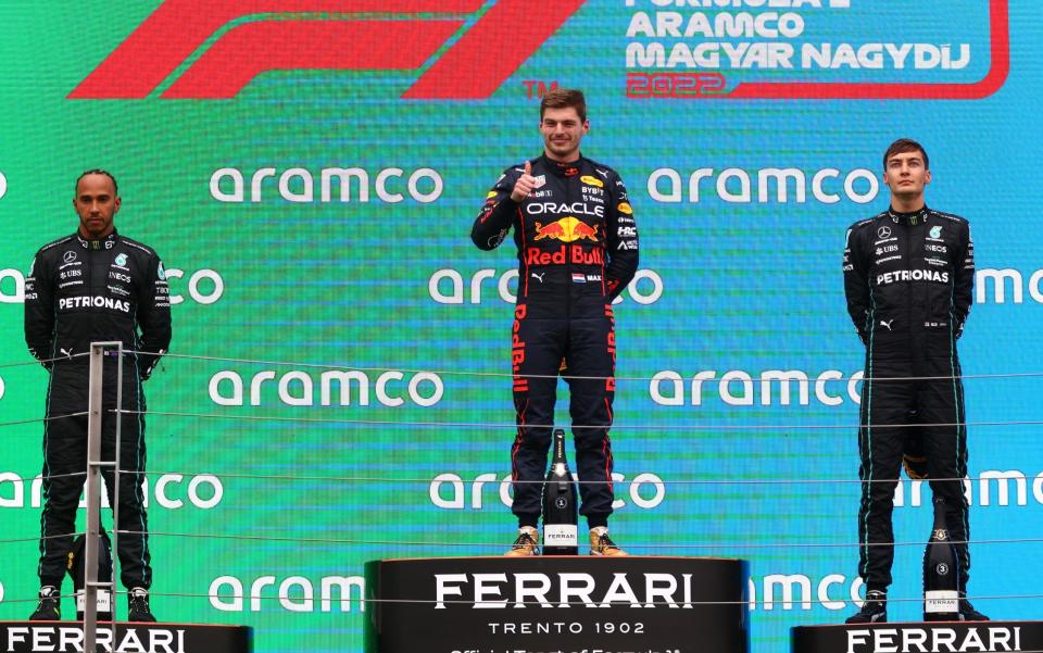 Max Verstappen (centre), Lewis Hamilton (left) and George Russell (right) on the podium - GETTY IMAGES