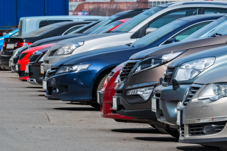 A row of cars in a parking lot