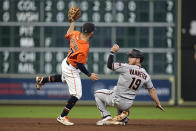 Arizona Diamondbacks' Josh VanMeter (19) looks back after being tagged out by Houston Astros second baseman Jose Altuve while trying to steal second base during the eighth inning of a baseball game Friday, Sept. 17, 2021, in Houston. (AP Photo/David J. Phillip)