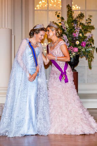 <p>Patrick van Katwijk/Getty </p> Queen Mathilde of Belgium and Queen Maxima of The Netherlands