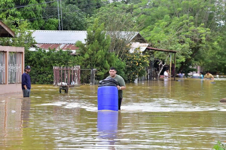 People try to save their belongings while leaving their homes after flooding due to Storm Eta, in El Progreso, Honduras (EPA-EFE)