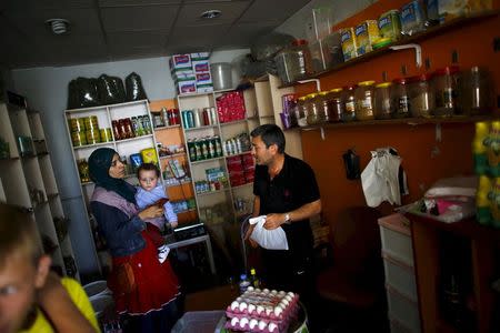 File photo of a Syrian woman who had fled the war in her homeland shopping at a market in a low-income neighborhood of Ankara, Turkey September 29, 2015. REUTERS/Umit Bektas/Files