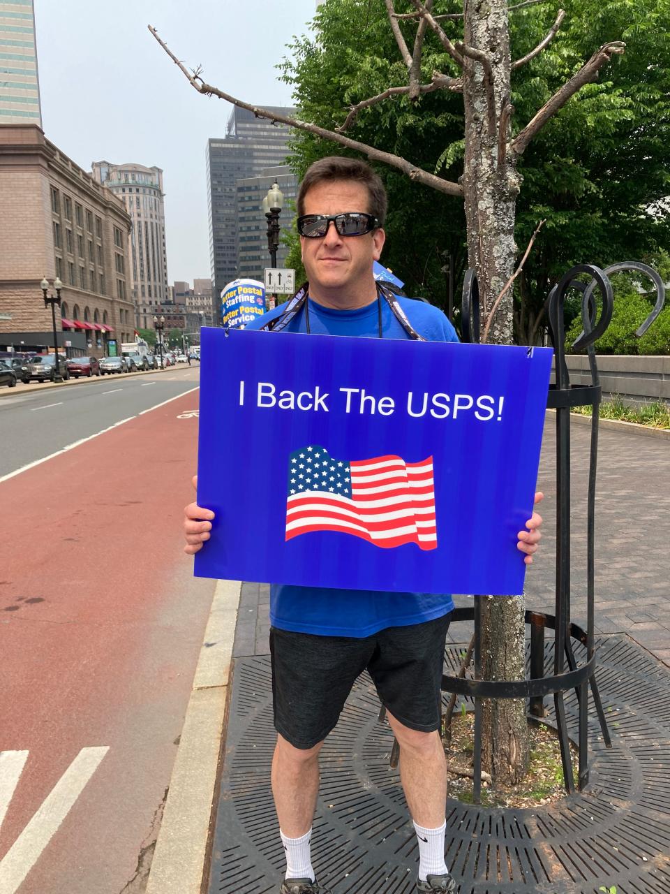 Robert Dunn of Groton, a window clerk, traveled to Boston to rally for less service cuts, higher staffing in the U.S. Postal Service.