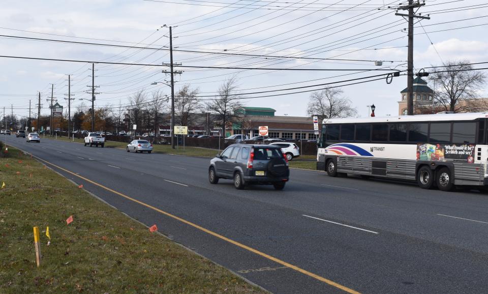 An NJ Transit bus stops Tuesday on Route 70 in Cherry Hill, where a woman was fatally struck after exiting a bus and trying to cross the highway on Thanksgiving Day.