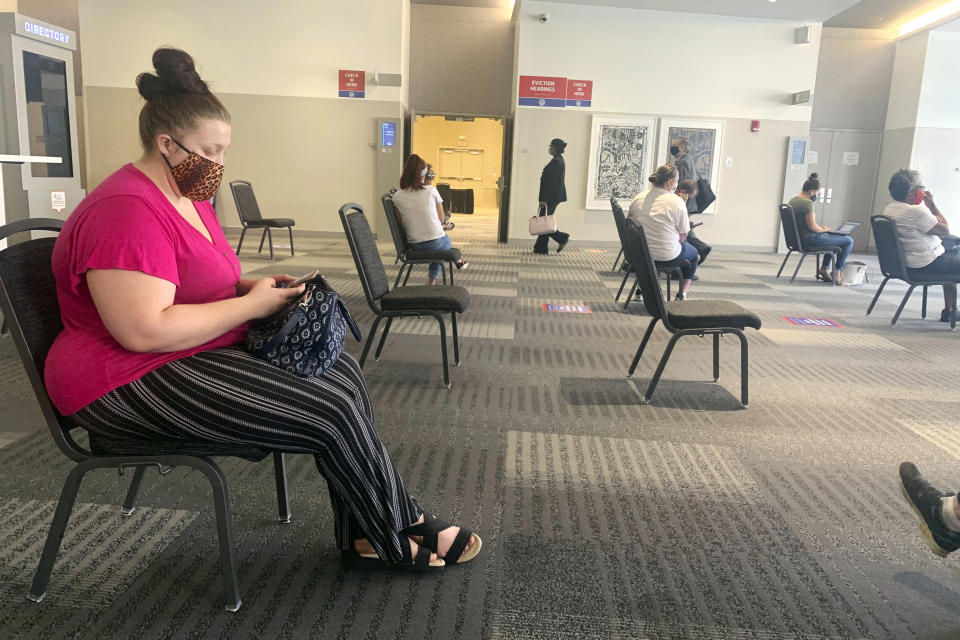 Amanda Wood, 23, waits to fight an impending eviction notice July 31, 2020, at the Greater Columbus Convention Center in Columbus, Ohio. Wood lost her job at a claims management company in early April. The following day, the mother of a 6-month-old found out she was pregnant again. Now, she is two months behind rent and can’t figure out a way to make ends meet. (AP Photo/Farnoush Amiri)