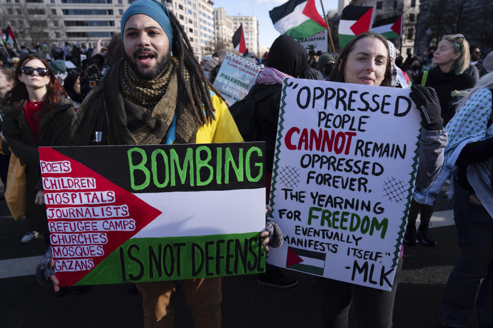 Demonstrators carry signs as they rally during the March on Washington for Gaza at Freedom Plaza in Washington, Saturday, Jan. 13, 2024. (AP Photo/Jose Luis Magana)