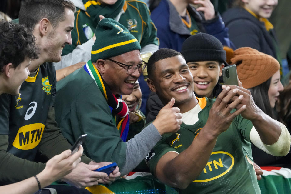 South Africa's Damian Willemse takes selfie with fans following the second Rugby Championship test match between the Wallabies and the Springboks in Sydney, Australia, Saturday, Sept. 3, 2022. (AP Photo/Mark Baker)