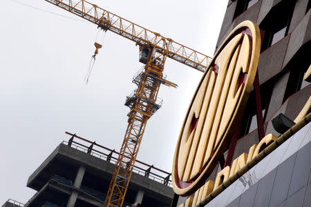 FILE PHOTO: A logo on the CITIC Building is pictured next to a construction site in Beijing, China June 23, 2017. REUTERS/Jason Lee/File Photo