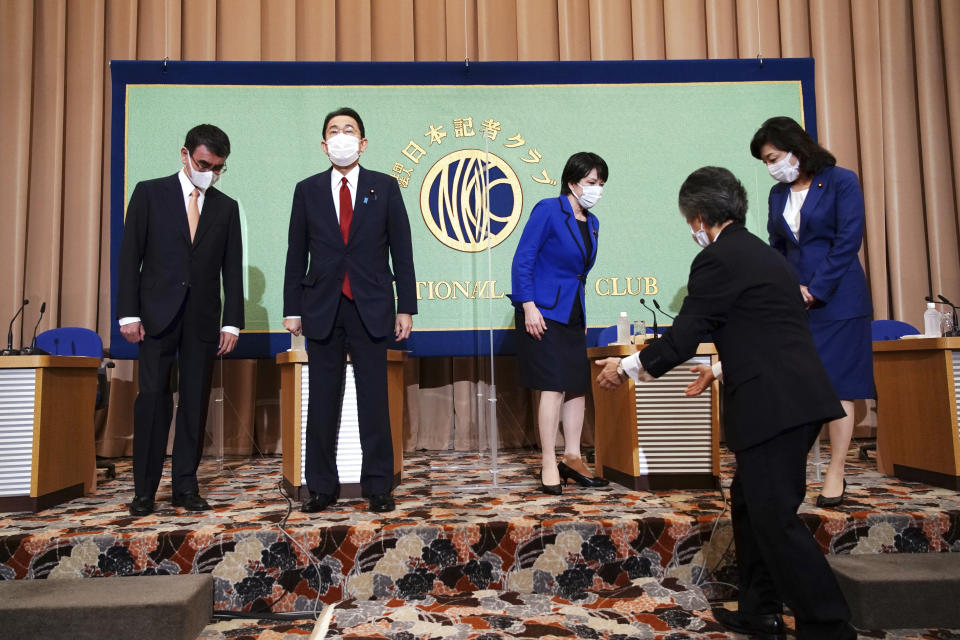 Candidates for the presidential election of the ruling Liberal Democratic Party prepare for a group photo, prior to a debate session held by Japan National Press club Saturday, Sept. 18, 2021 in Tokyo. The contenders are from left to right, Taro Kono, the cabinet minister in charge of vaccinations, Fumio Kishida, former foreign minister, Sanae Takaichi, former internal affairs minister, and Seiko Noda, former internal affairs minister. (AP Photo/Eugene Hoshiko, Pool)