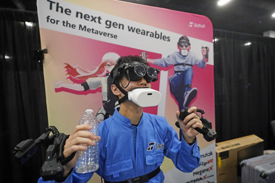 The "mutalk" leakage voice suppression microphone is demonstrated with the Megane X, an ultra-lightweight and ultra-compact VR headset and the Flip VR, a hand controller at the Shiftall booth during CES Unveiled, before the CES tech show, Tuesday, Jan. 3, 2023, in Las Vegas. (AP Photo/Rick Bowmer)