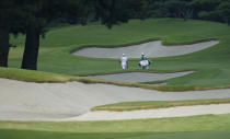 South Africa's Christiaan Bezuidenhout, left, walks on the 14th fairway during a practice round of the men's golf event at the 2020 Summer Olympics, Tuesday, July 27, 2021, at the Kasumigaseki Country Club in Kawagoe, Japan, (AP Photo/Matt York)